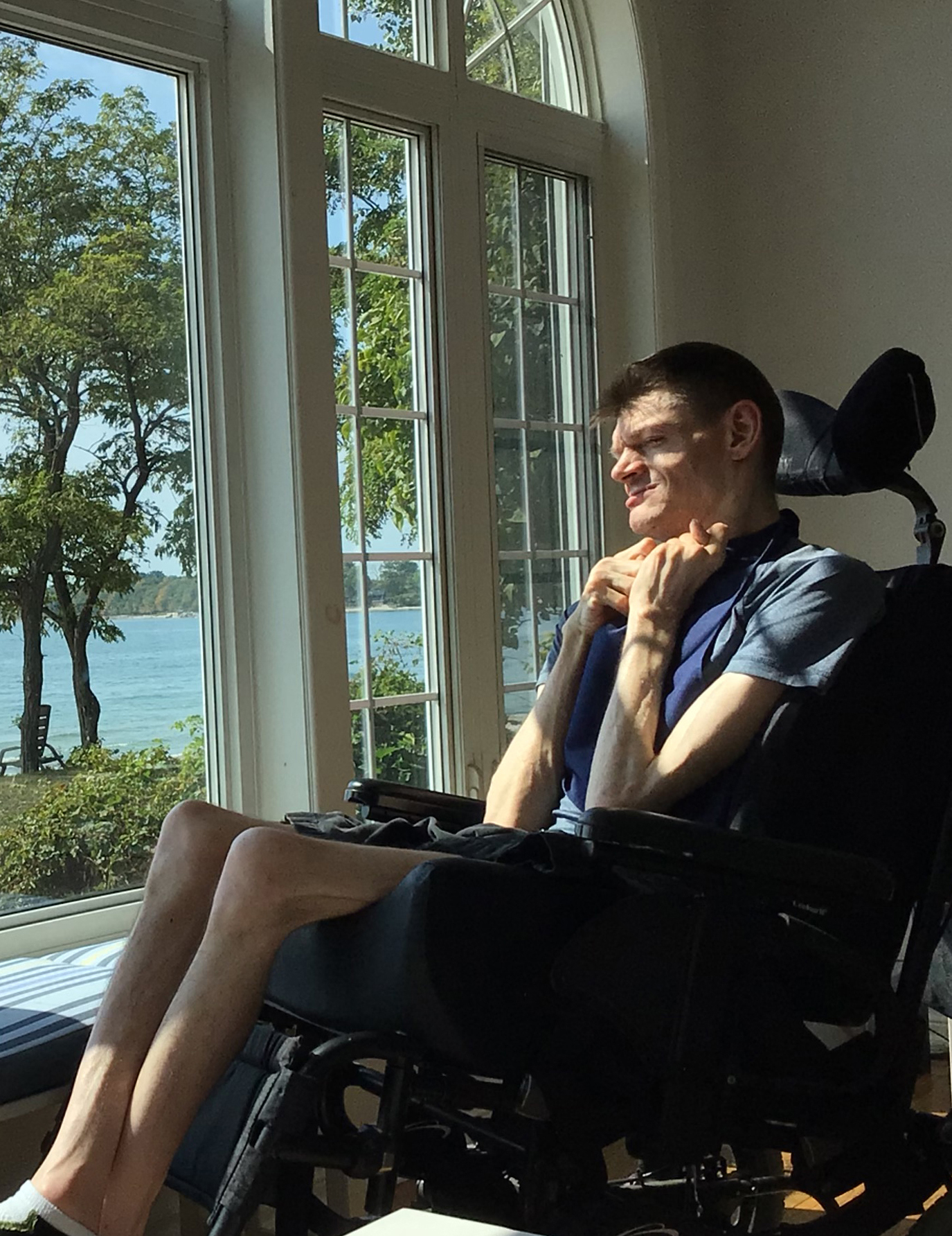 Peter at the cottage - man looking out window at lake