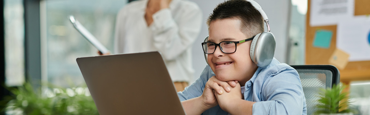Our Partners - young man at computer with headphones on