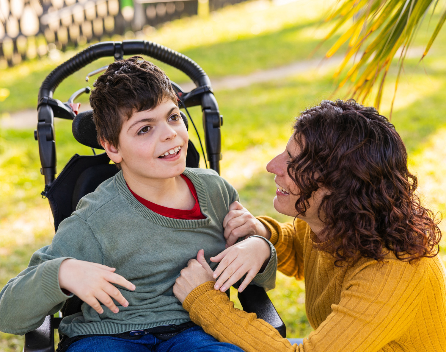 Family Support Services - child outside in wheelchair with mom